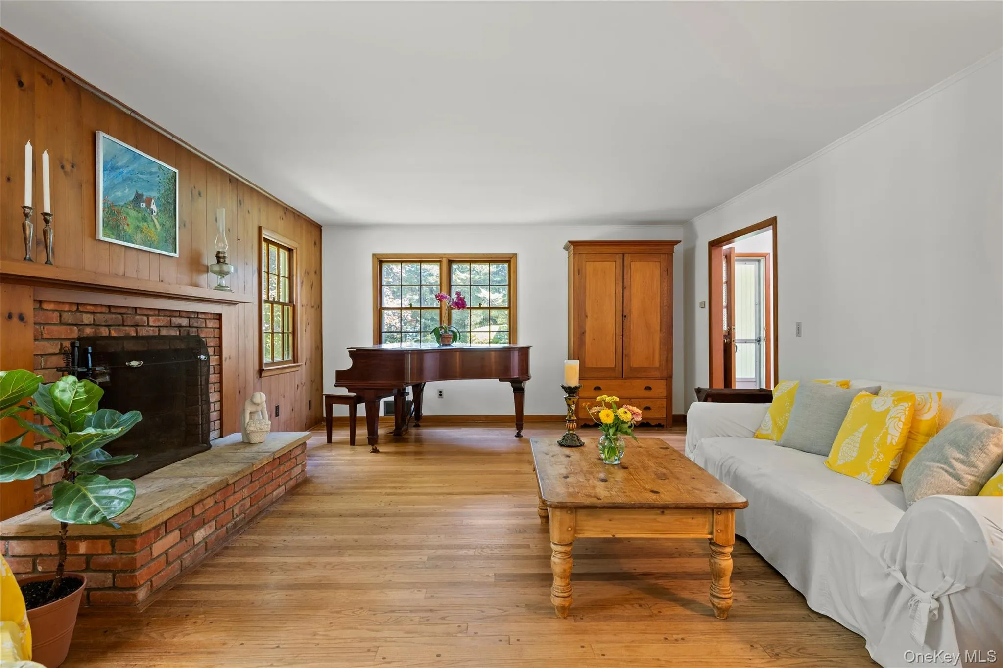 Living room with full paneled wall and 2nd entrance into the hall/entryway Living room with full paneled wall and 2nd entrance into the hall/entryway