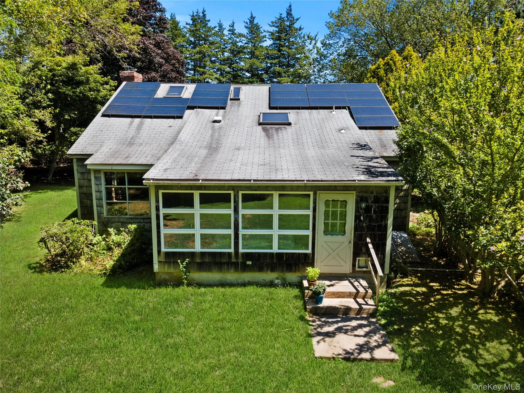 Back of property featuring roof mounted solar panels, Back of property featuring roof mounted solar panels,