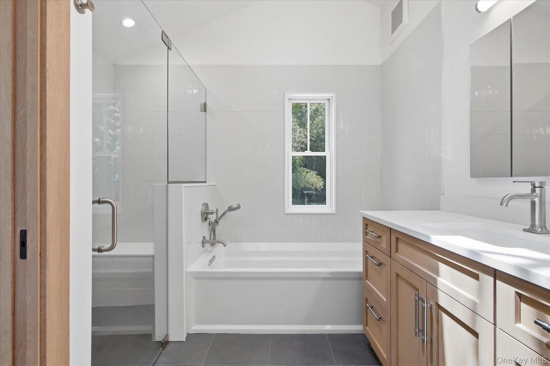 With glass enclosed shower, vanity, soaking tub and self cleaning toilet With glass enclosed shower, vanity, soaking tub and self cleaning toilet