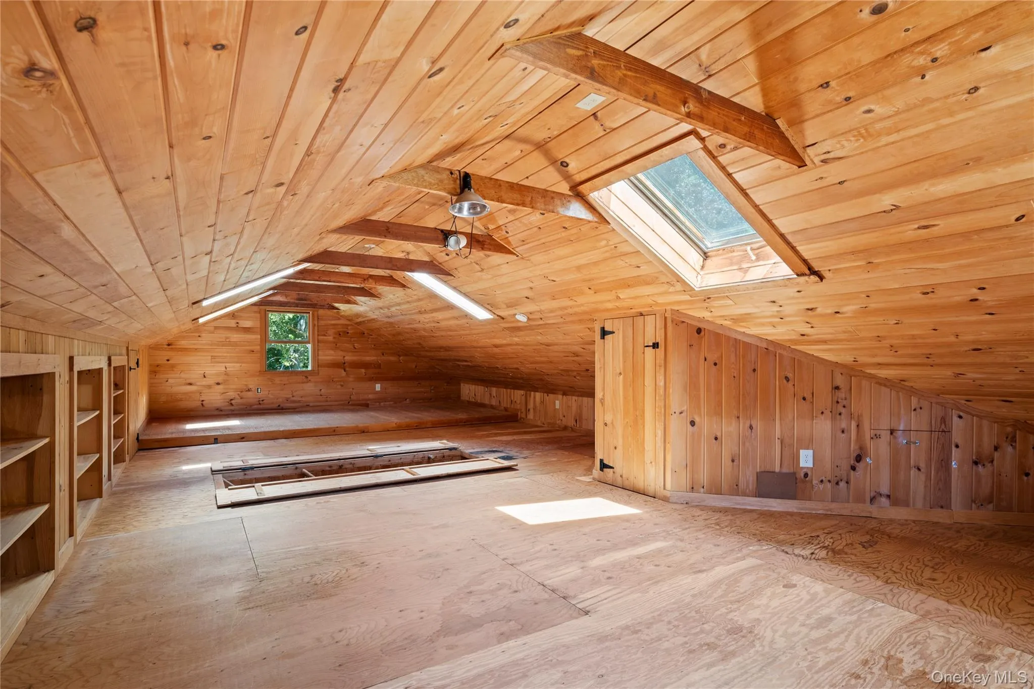 Full staircase leads you to the unheated space with skylights and storage Full staircase leads you to the unheated space with skylights and storage