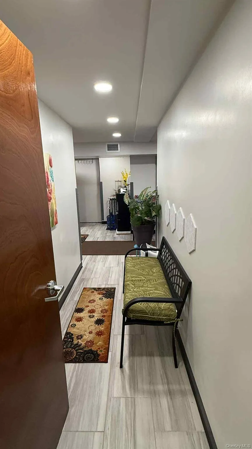 Hallway featuring light wood-style flooring and recessed lighting Hallway featuring light wood-style flooring and recessed lighting