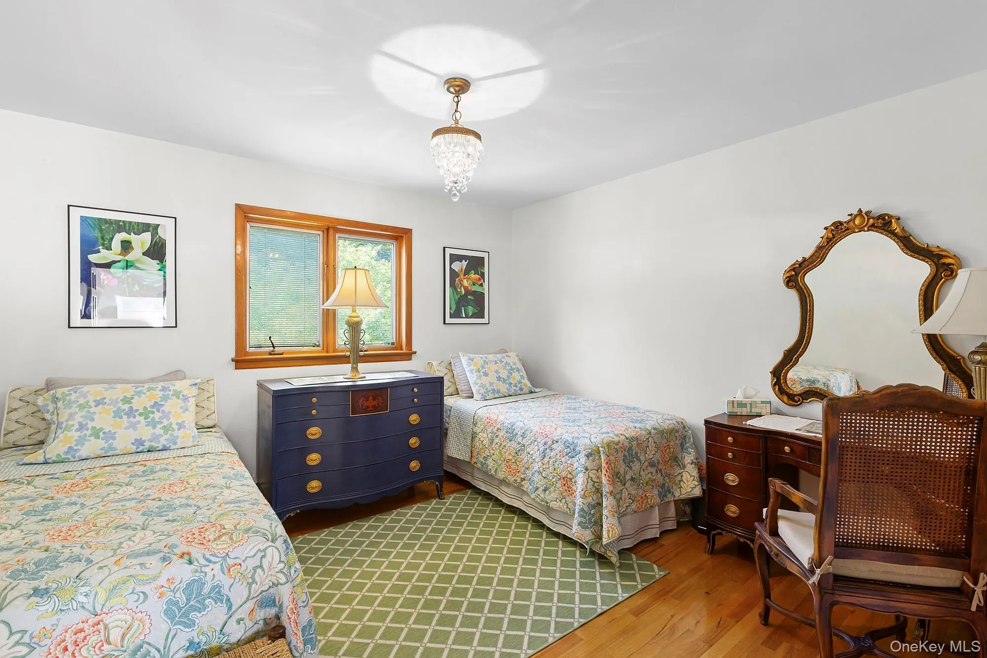 Bedroom with wood finished floors and a chandelier Bedroom with wood finished floors and a chandelier