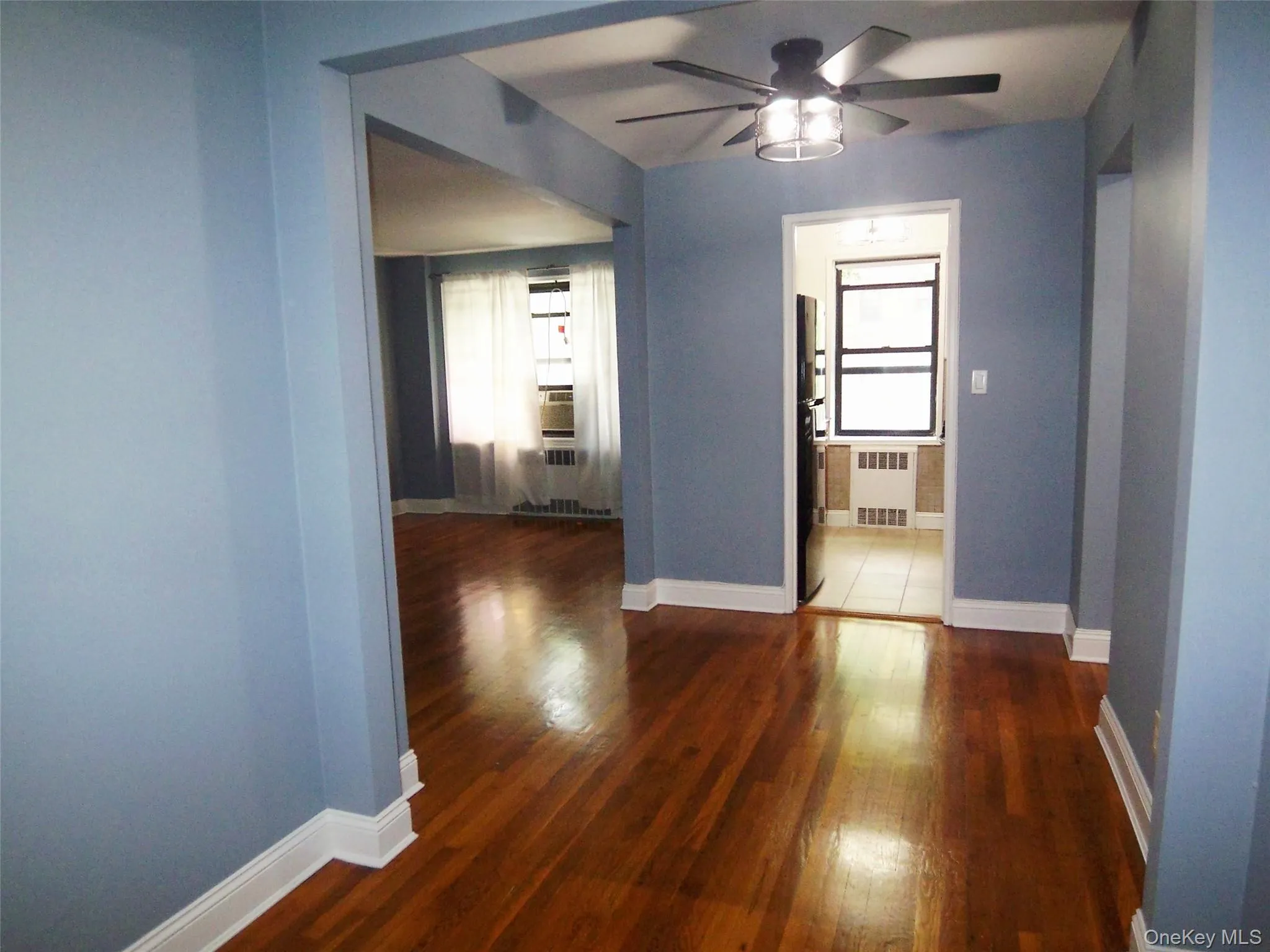 Hall with dark wood-style flooring and radiator Hall with dark wood-style flooring and radiator