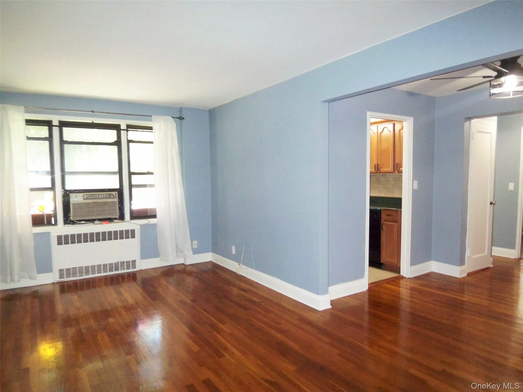 Large Living room with dark wood-type flooring Large Living room with dark wood-type flooring
