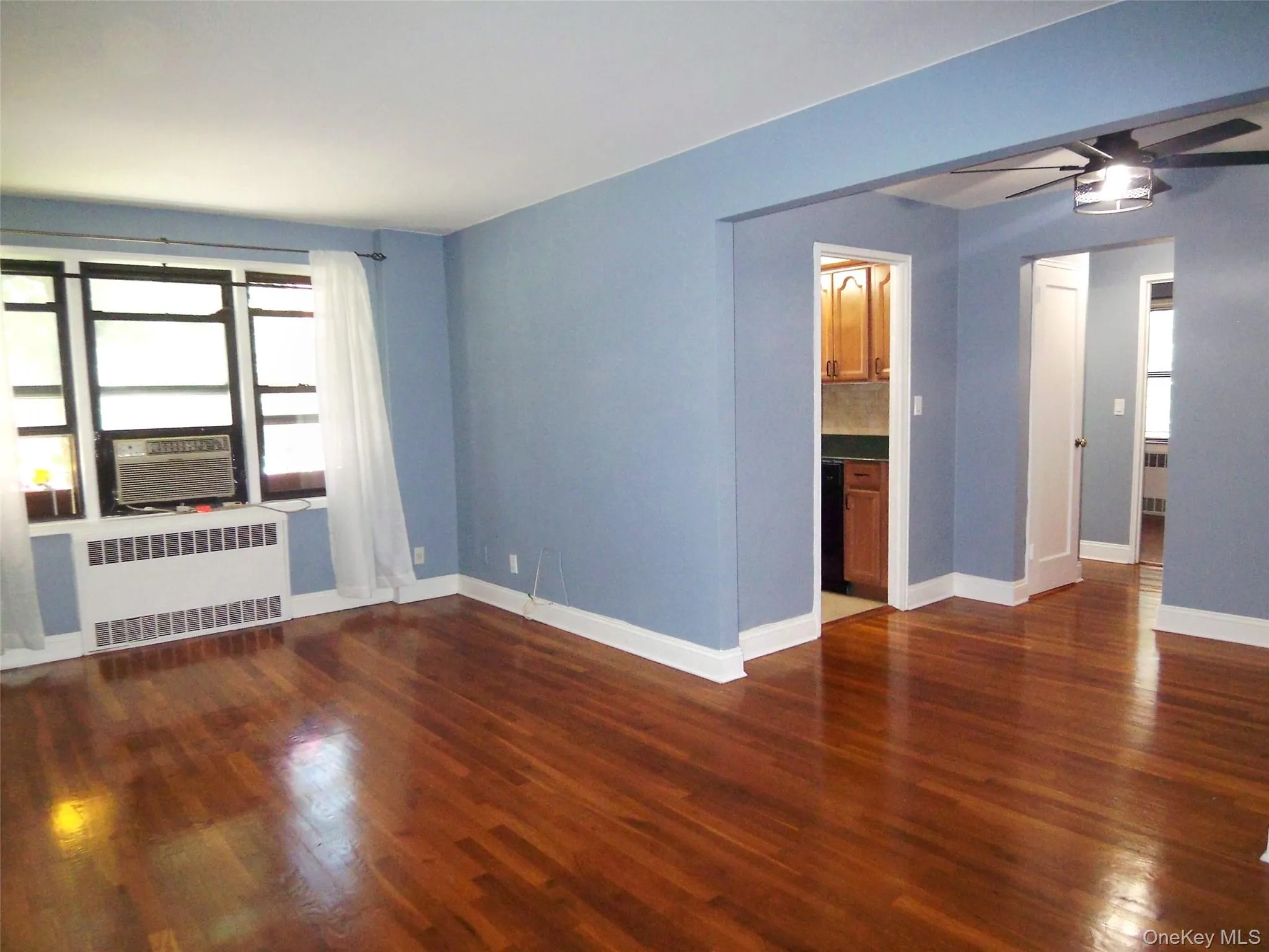 Large Living room with dark wood-type flooring Large Living room with dark wood-type flooring