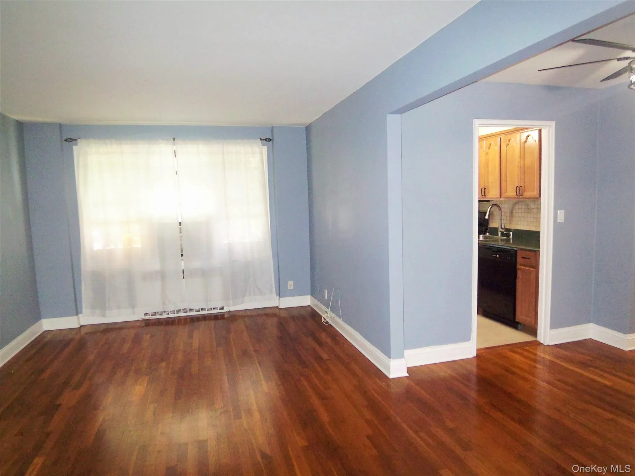Large Living room with dark wood-type flooring Large Living room with dark wood-type flooring