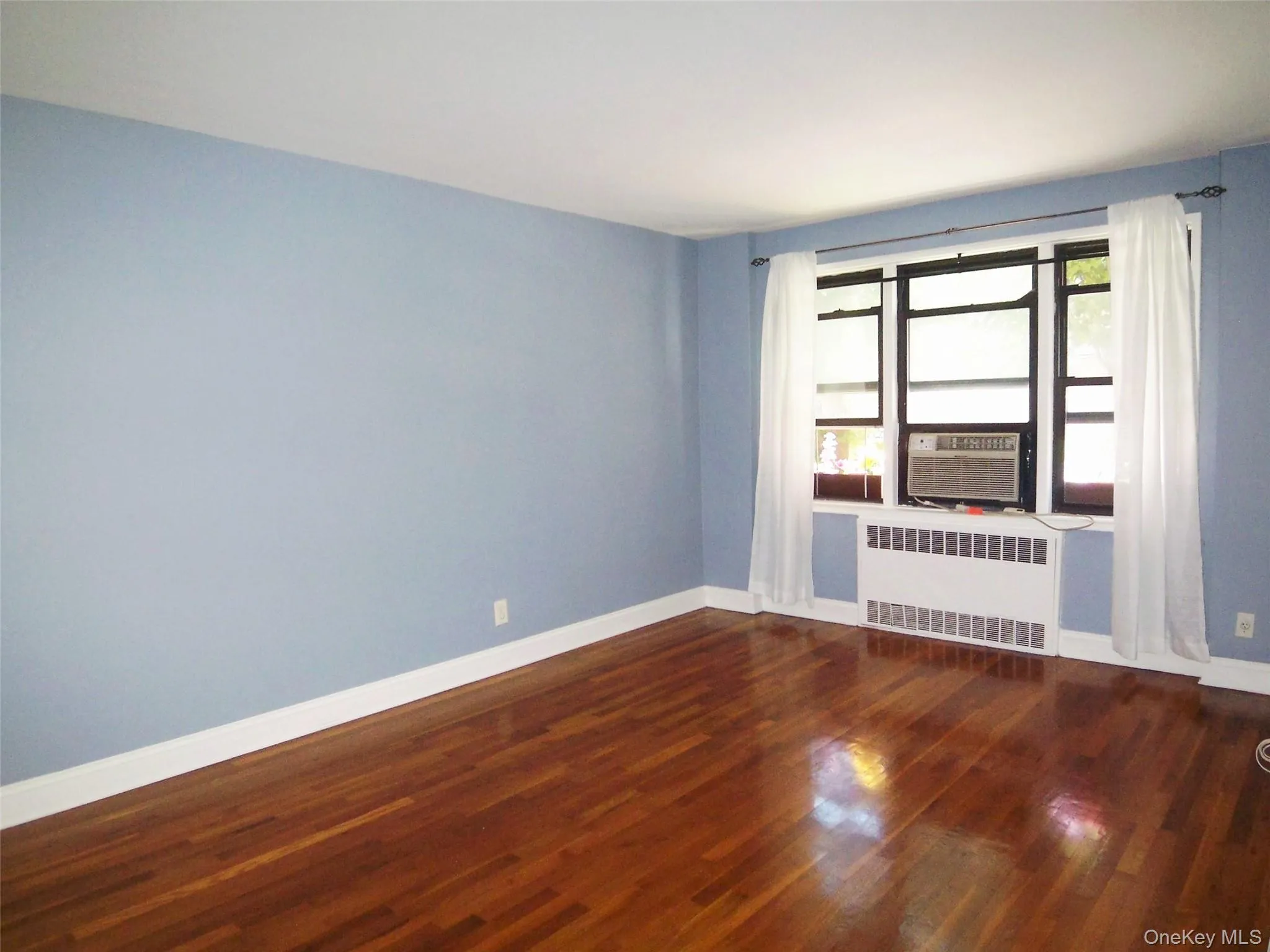 Large Living room with dark wood-type flooring Large Living room with dark wood-type flooring