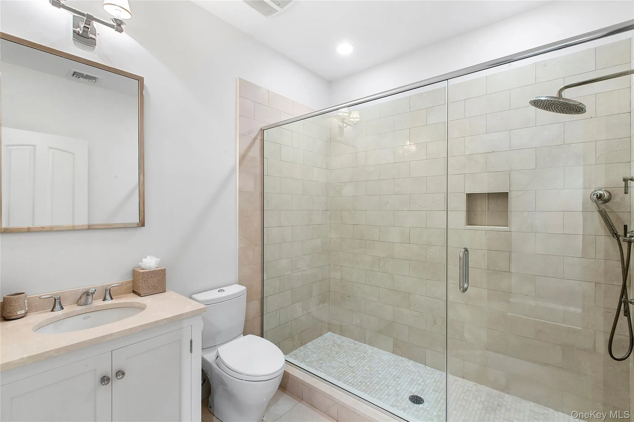 Bathroom with a shower stall and vanity