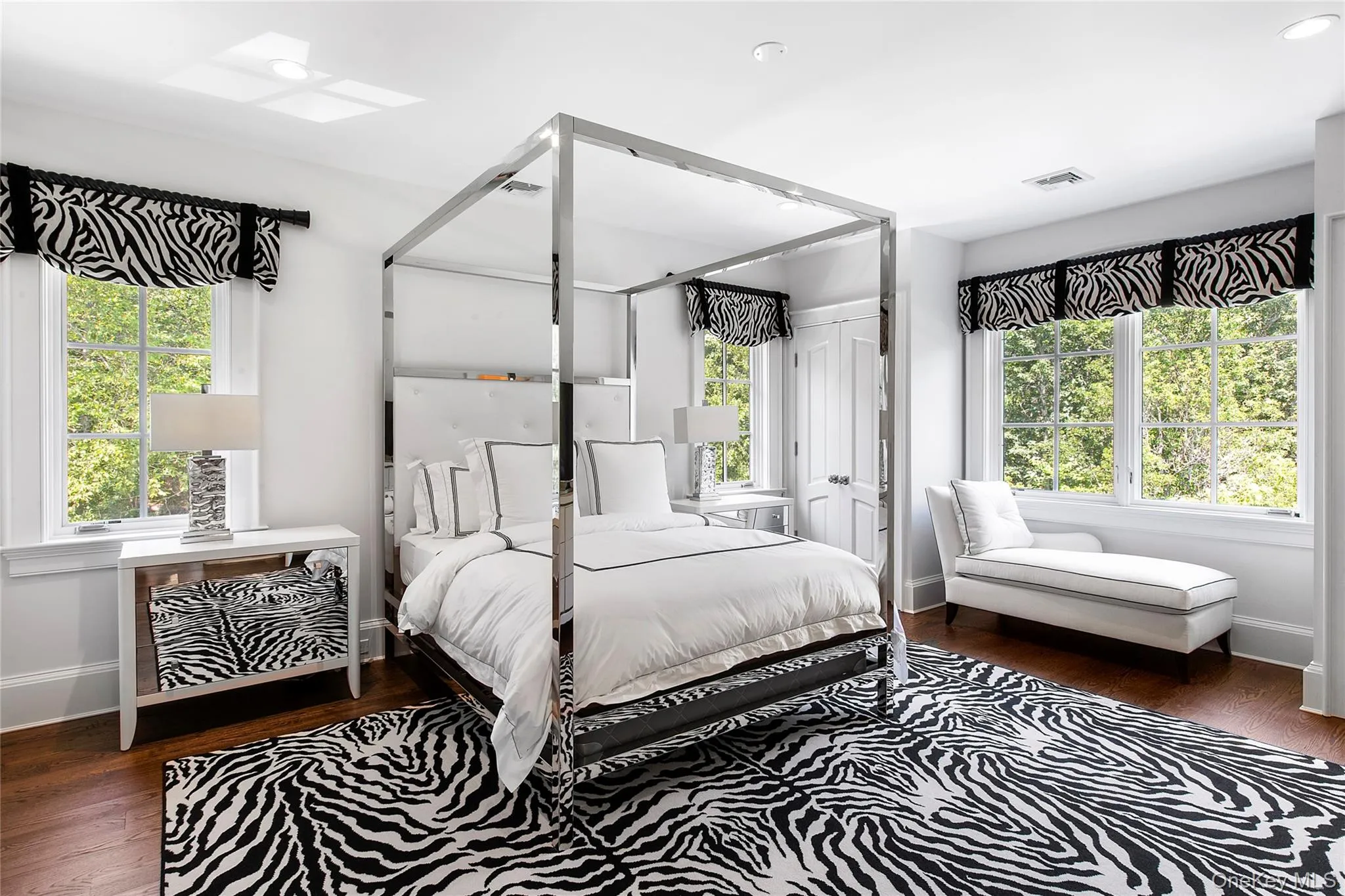 Bedroom featuring dark wood finished floors, multiple windows, and recessed lighting