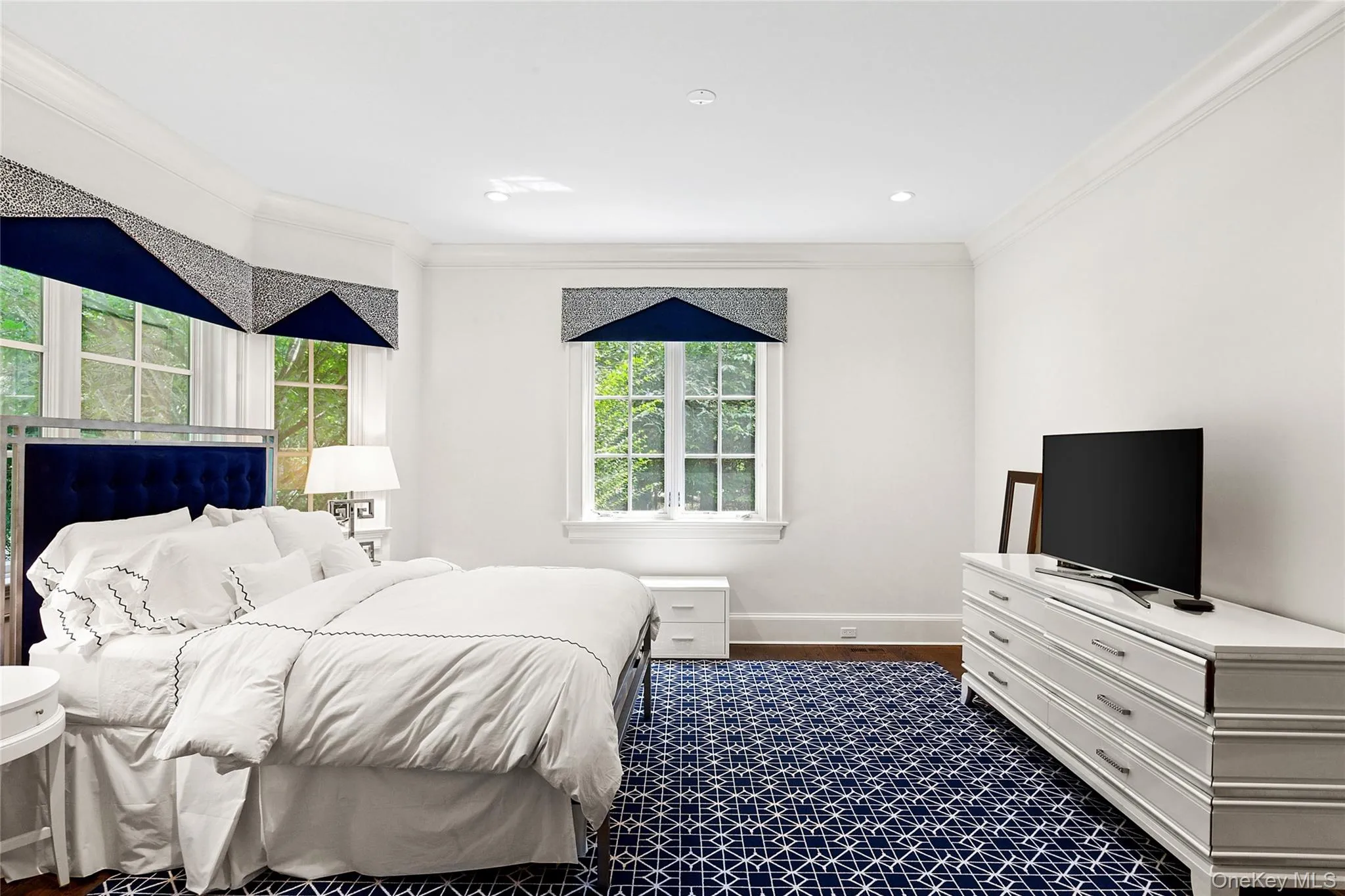 Bedroom with crown molding, dark wood finished floors, and recessed lighting