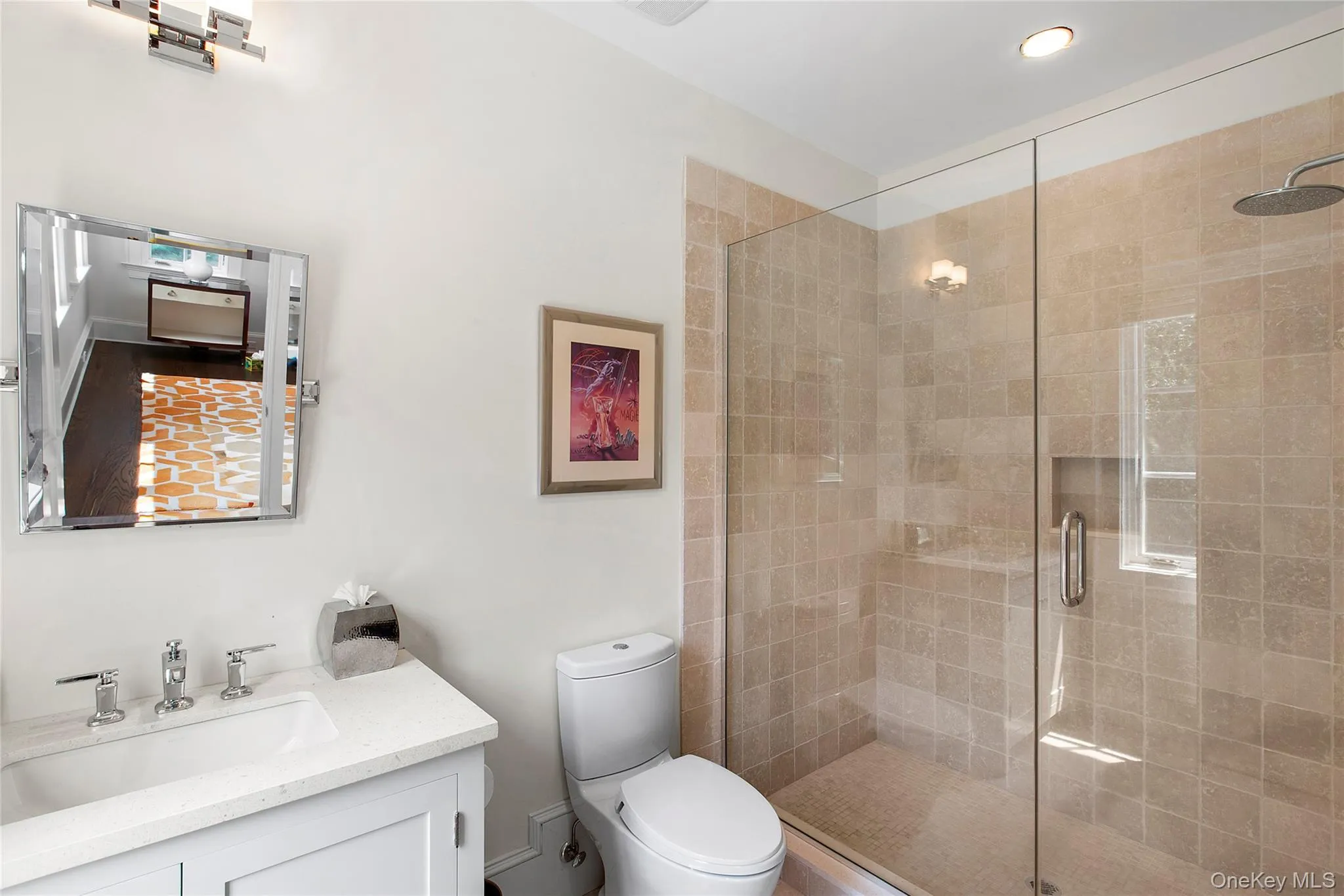 Bathroom featuring a stall shower and vanity