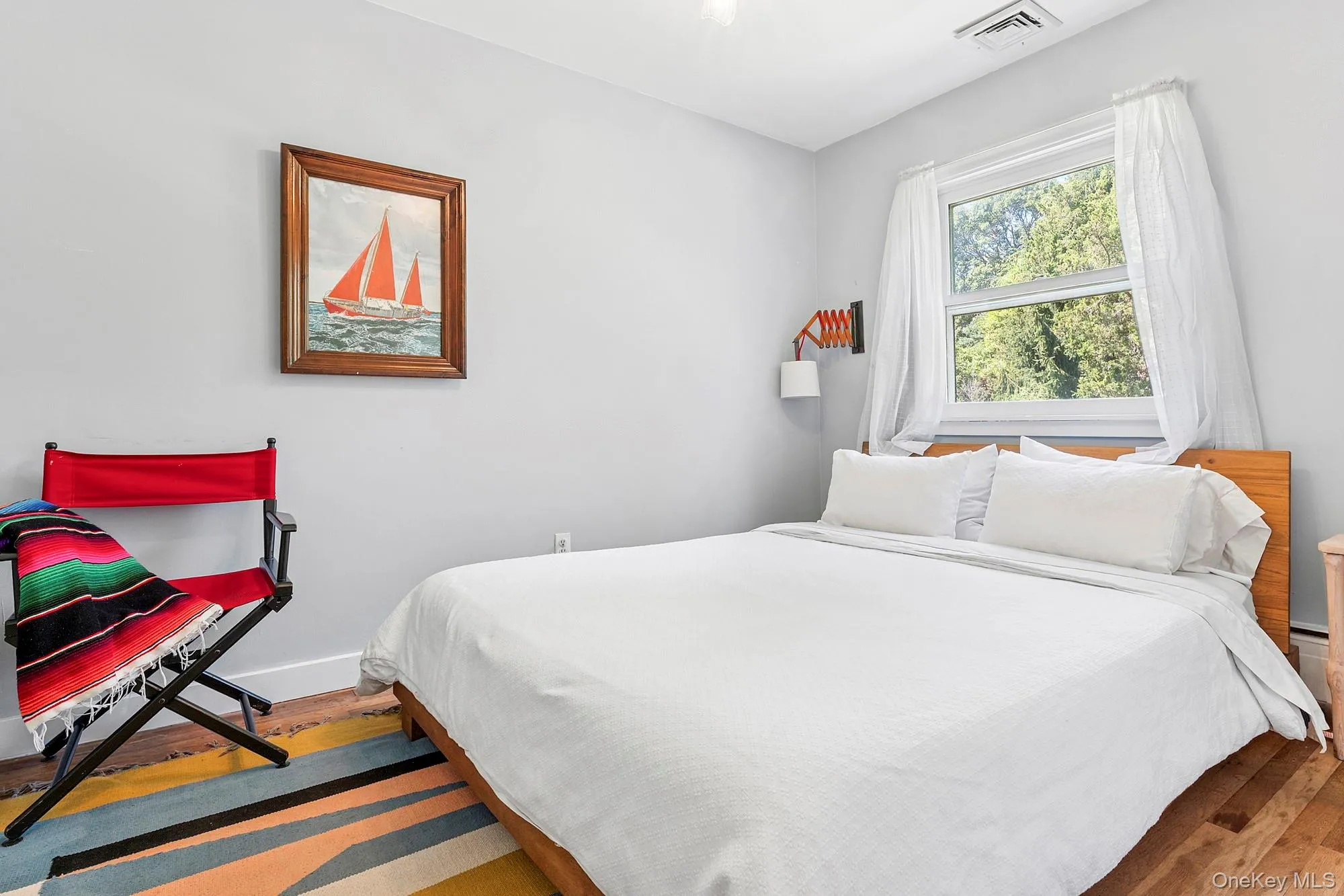 Bedroom featuring dark wood-type flooring and baseboards Bedroom featuring dark wood-type flooring and baseboards