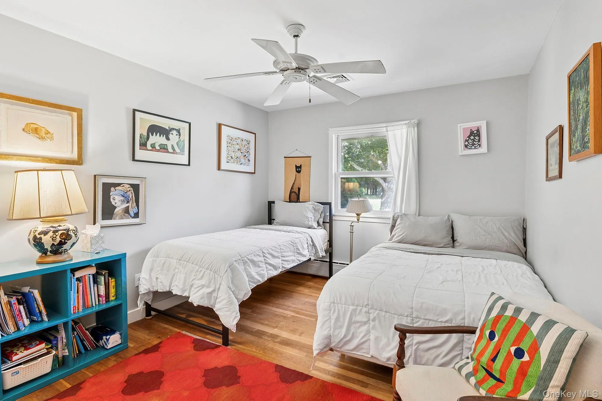 Bedroom featuring wood finished floors and a ceiling fan Bedroom featuring wood finished floors and a ceiling fan