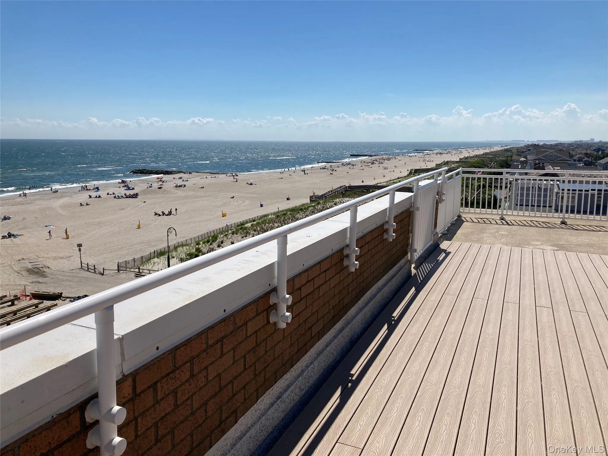 Wooden terrace with view of water and beach Wooden terrace with view of water and beach