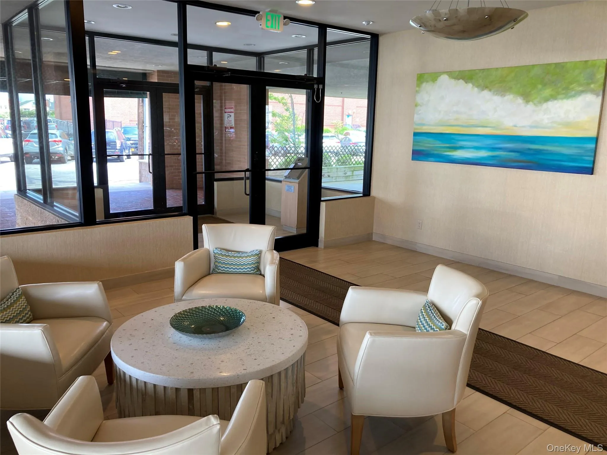 Building lobby featuring wallpapered walls and recessed lighting Building lobby featuring wallpapered walls and recessed lighting