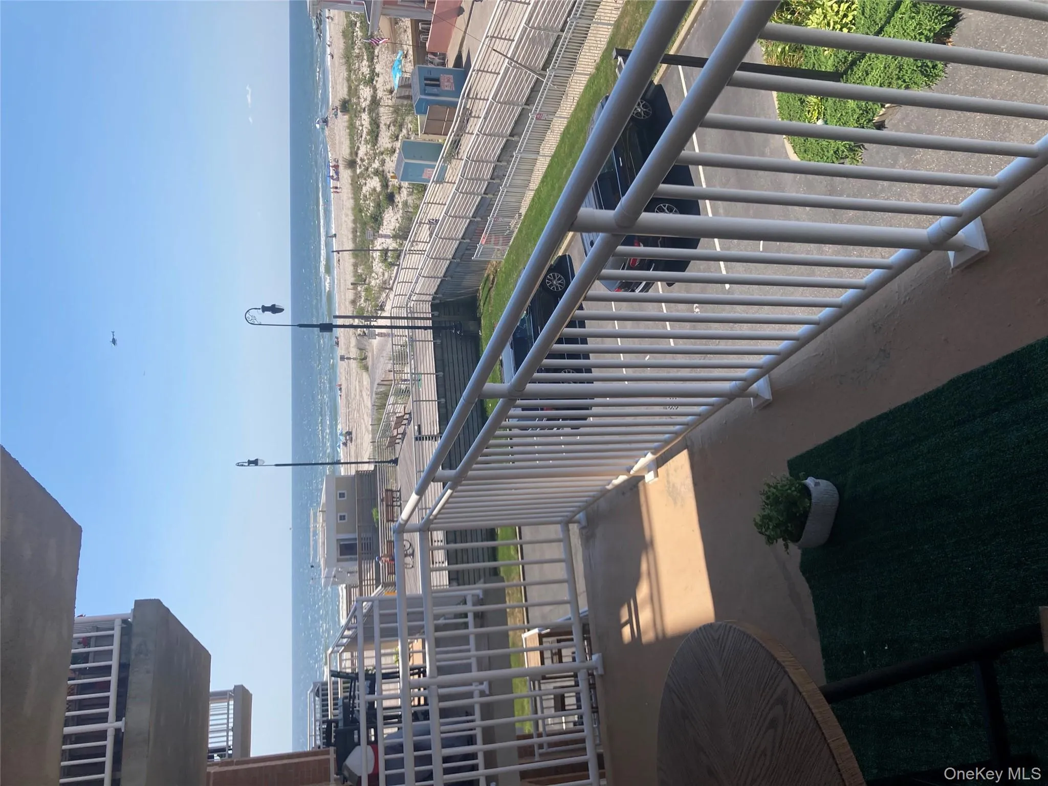 Balcony featuring view of water and beach Balcony featuring view of water and beach