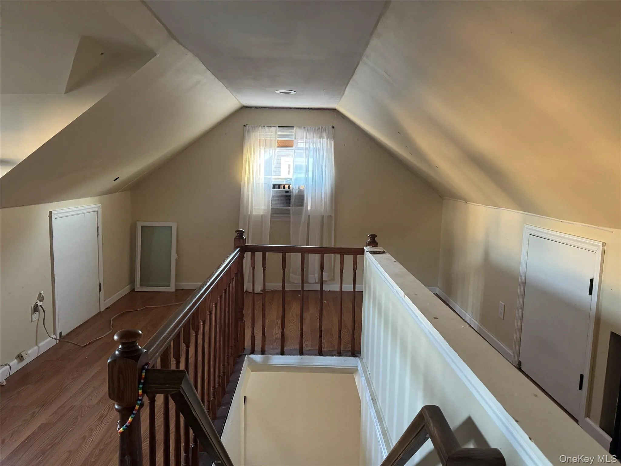 Additional living space with wood finished floors and vaulted ceiling Additional living space with wood finished floors and vaulted ceiling