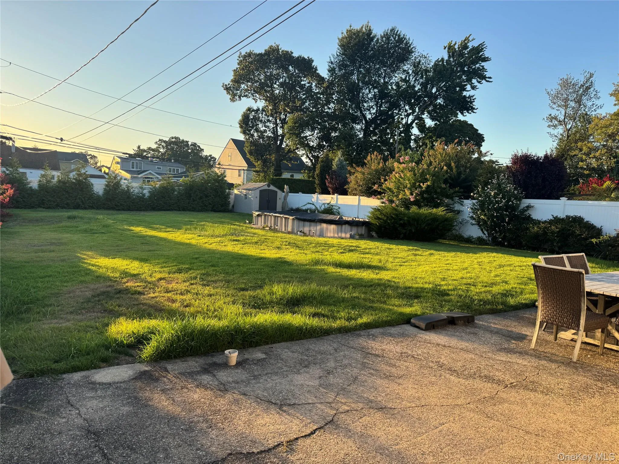 Fenced backyard featuring a storage unit and a patio Fenced backyard featuring a storage unit and a patio