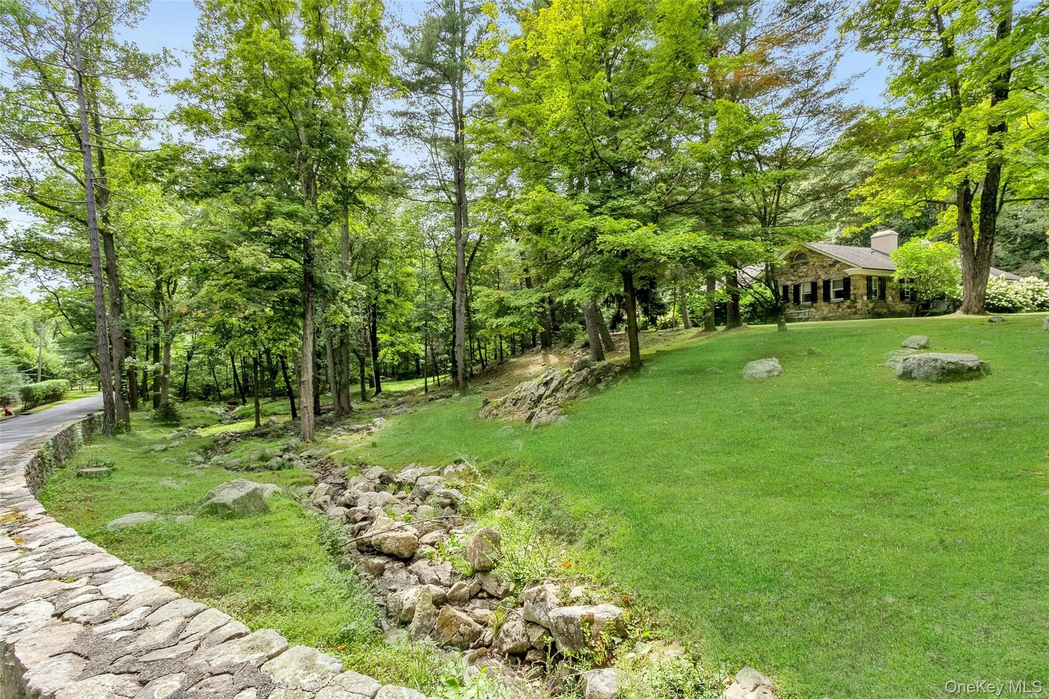 Stream and stone wall with lawn Stream and stone wall with lawn