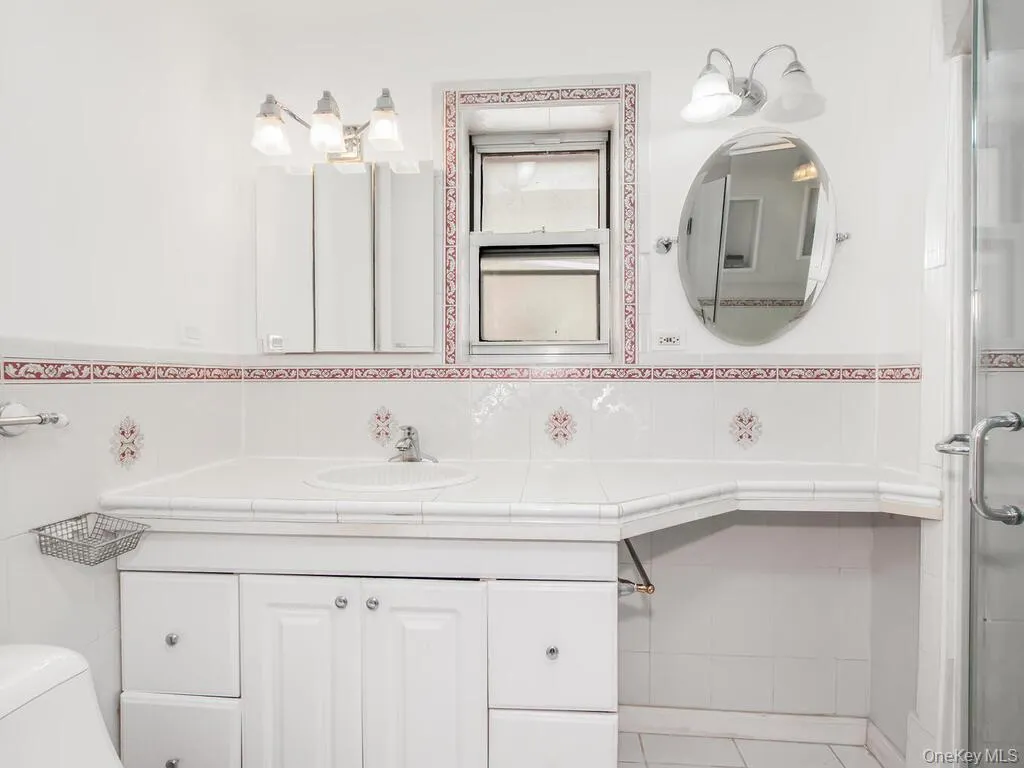 Bathroom with vanity and a shower stall Bathroom with vanity and a shower stall