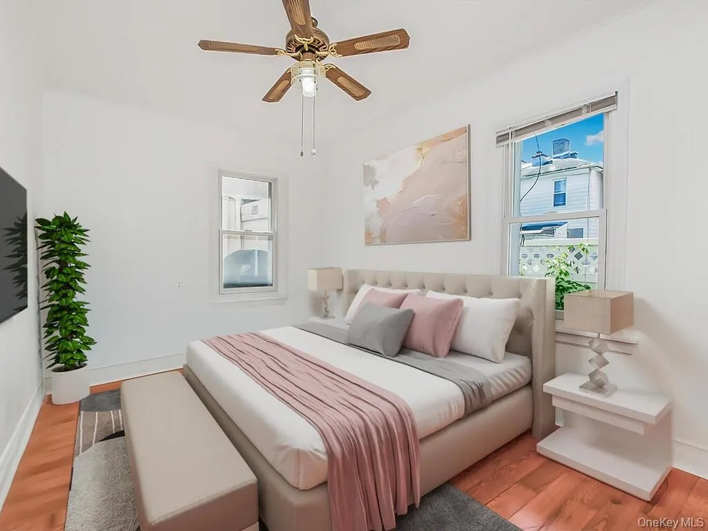 Bedroom featuring wood finished floors and a ceiling fan Bedroom featuring wood finished floors and a ceiling fan