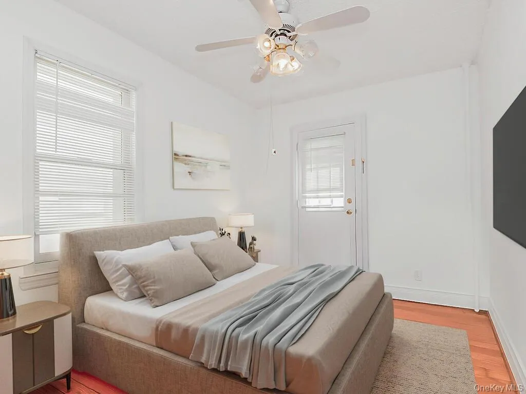 Bedroom featuring light wood-style flooring and a ceiling fan Bedroom featuring light wood-style flooring and a ceiling fan