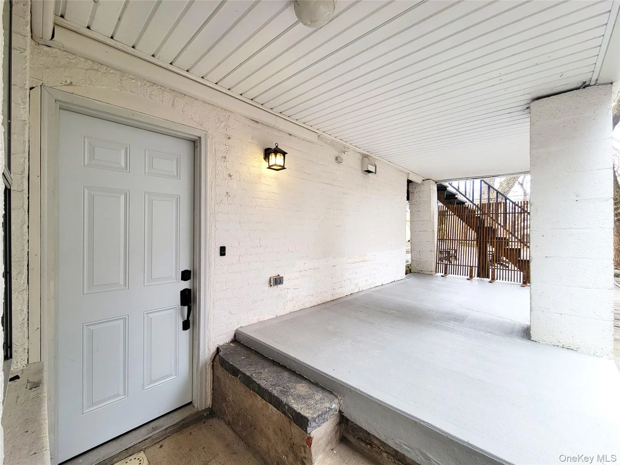Entrance to property with brick siding and a patio area Entrance to property with brick siding and a patio area