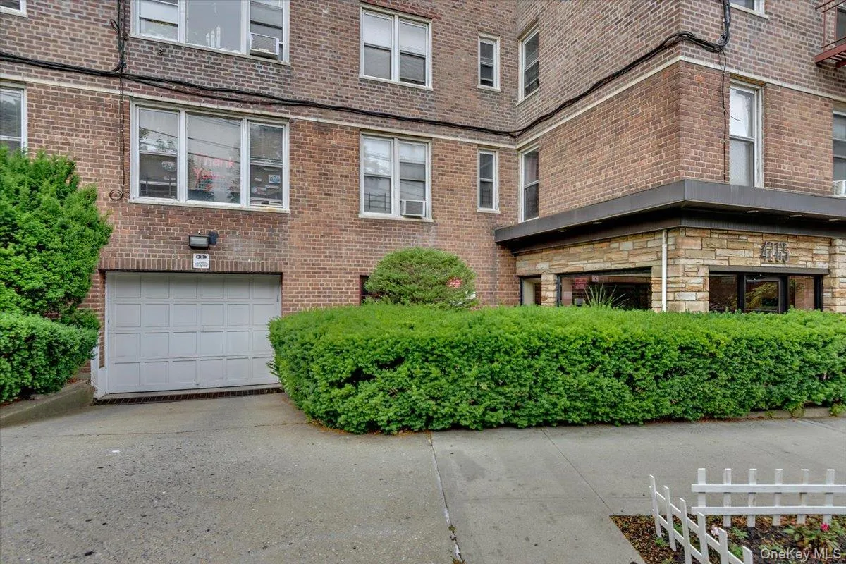 View of building exterior featuring a garage and driveway View of building exterior featuring a garage and driveway