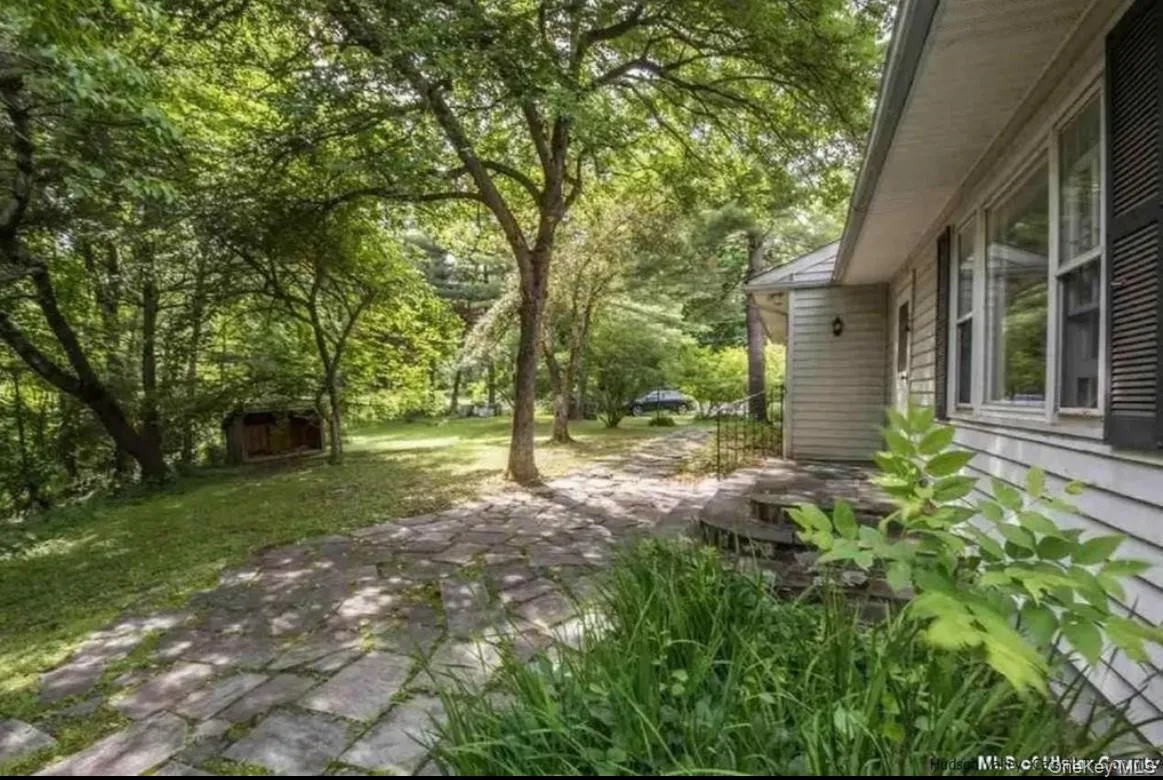 View of green lawn featuring a shed View of green lawn featuring a shed