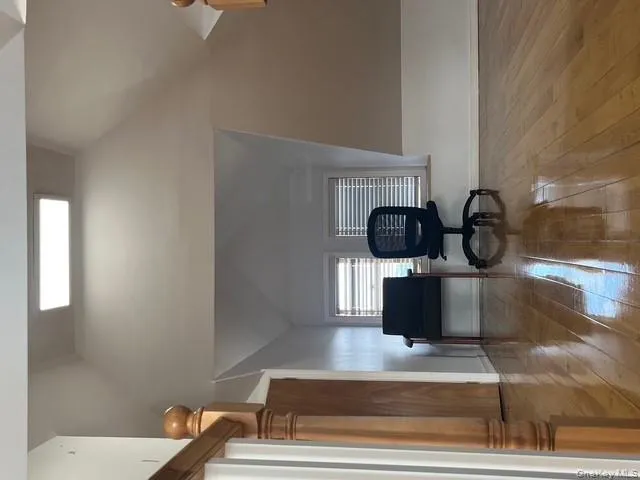 Living area with vaulted ceiling and light wood-style flooring Living area with vaulted ceiling and light wood-style flooring