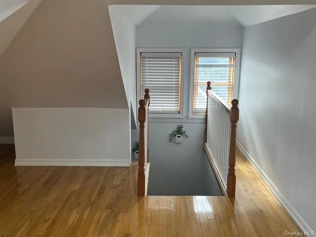 Stairs with vaulted ceiling and wood-type flooring Stairs with vaulted ceiling and wood-type flooring