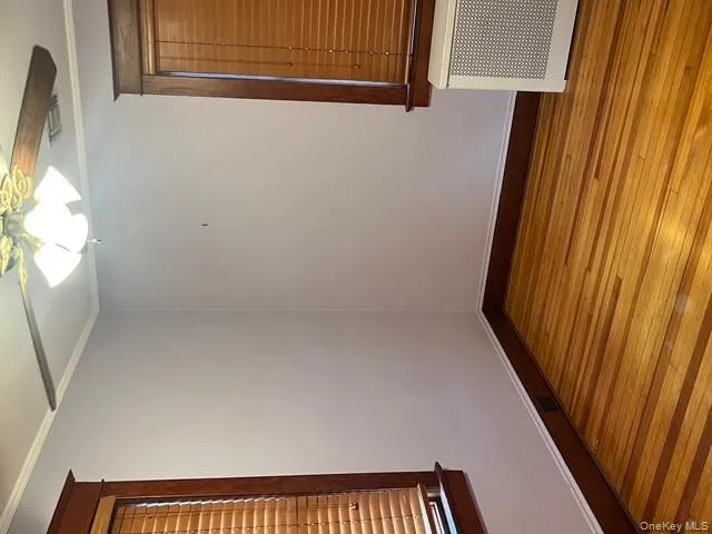 Empty room with ornamental molding, hardwood / wood-style floors, radiator, and ceiling fan Empty room with ornamental molding, hardwood / wood-style floors, radiator, and ceiling fan