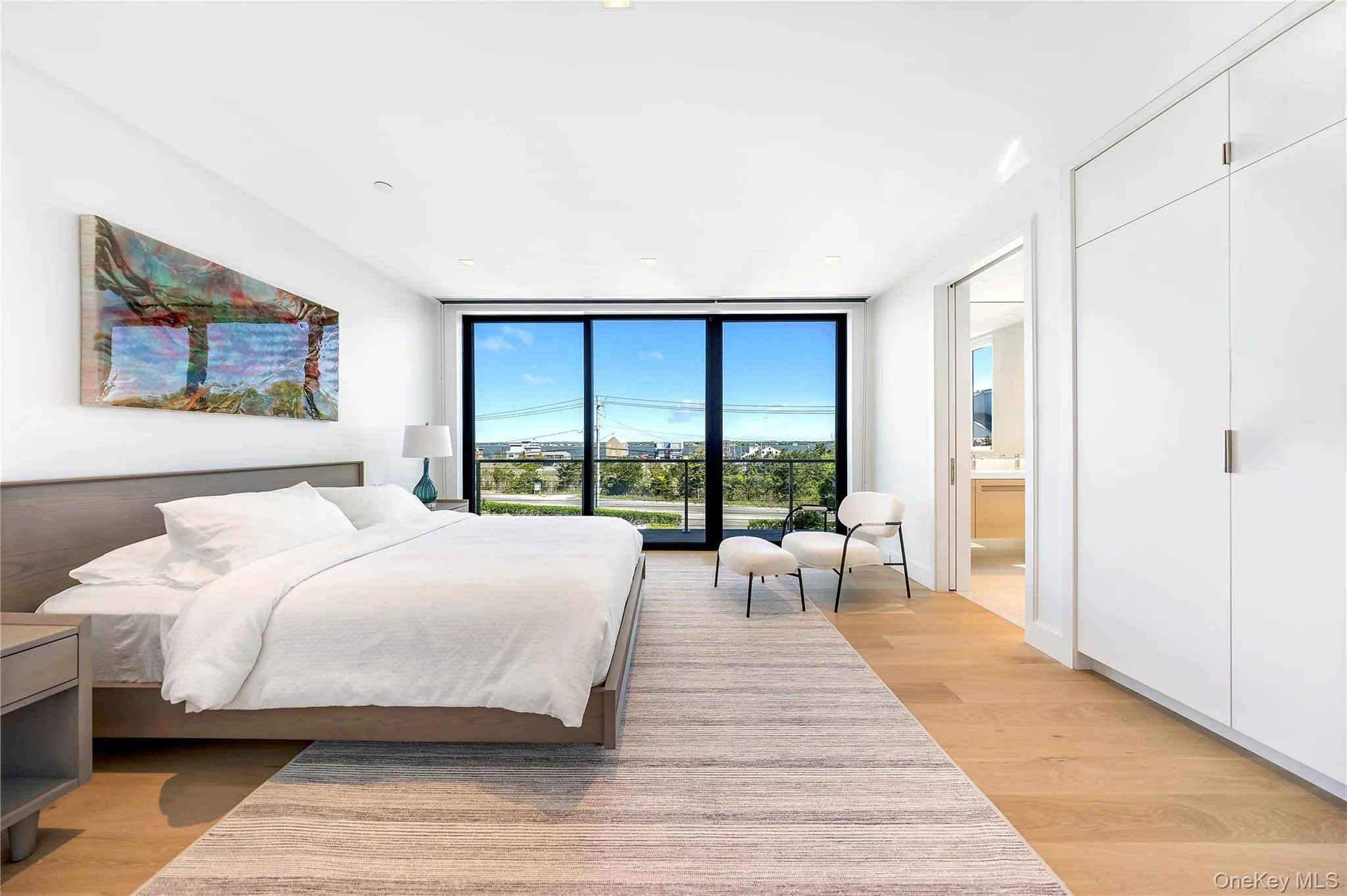 Bedroom featuring floor to ceiling windows, light wood-style floors, and recessed lighting Bedroom featuring floor to ceiling windows, light wood-style floors, and recessed lighting
