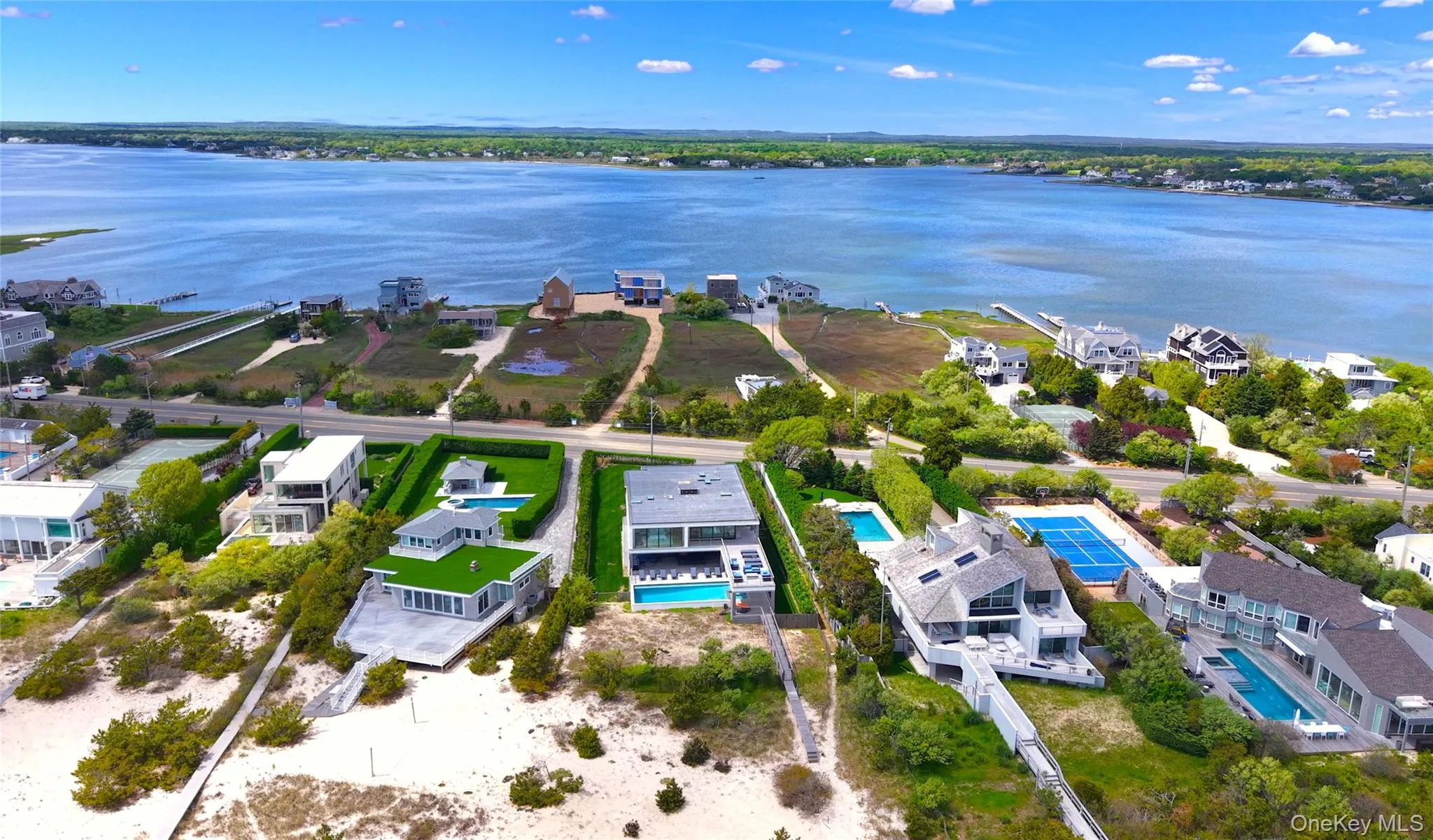 Aerial perspective of suburban area featuring a nearby body of water Aerial perspective of suburban area featuring a nearby body of water