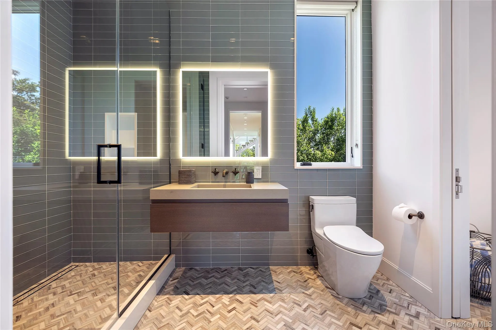 Bathroom featuring a shower stall, tile walls, and vanity Bathroom featuring a shower stall, tile walls, and vanity