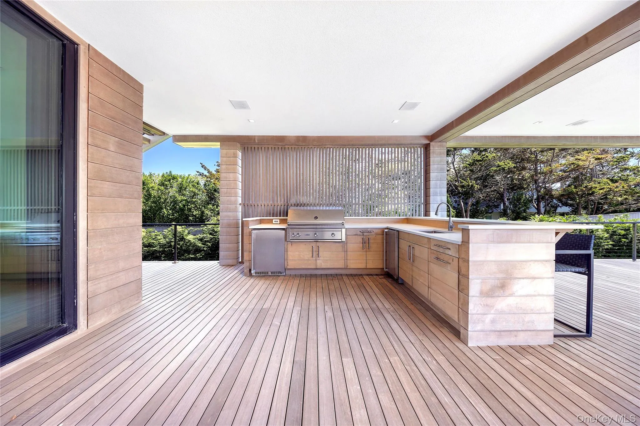 Deck with an outdoor kitchen and a sink Deck with an outdoor kitchen and a sink