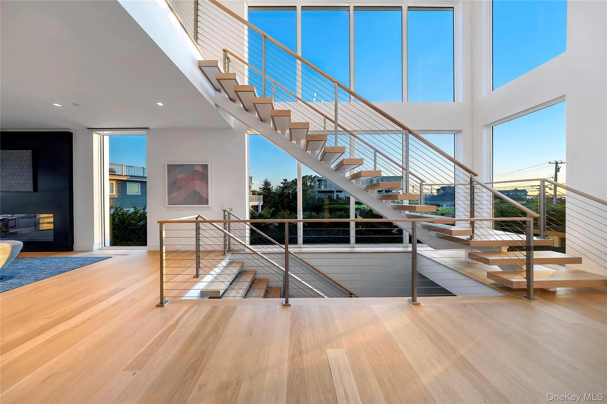 Stairs featuring wood finished floors, a high ceiling, and recessed lighting Stairs featuring wood finished floors, a high ceiling, and recessed lighting
