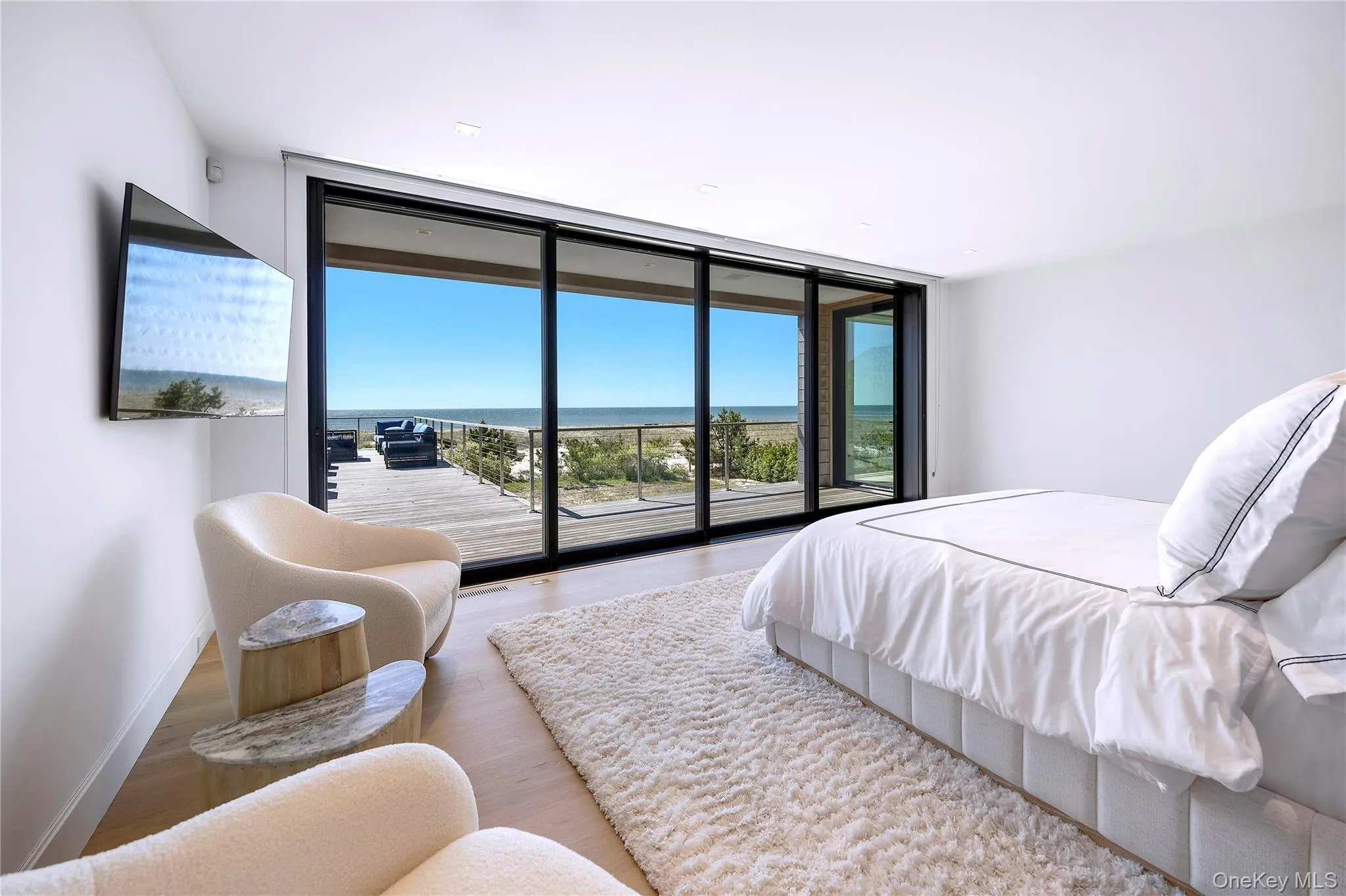 Bedroom with floor to ceiling windows, wood finished floors, and access to outside Bedroom with floor to ceiling windows, wood finished floors, and access to outside