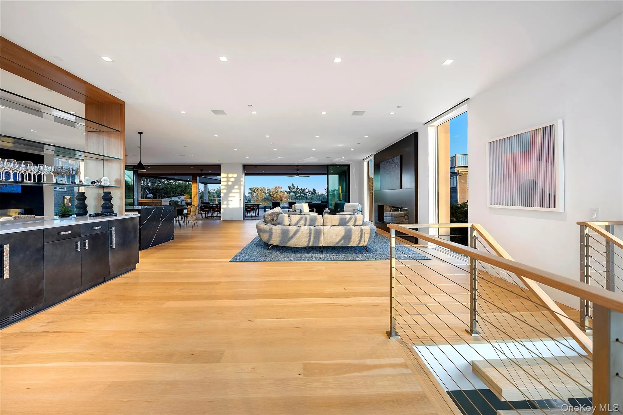 Living area with floor to ceiling windows, light wood finished floors, and recessed lighting Living area with floor to ceiling windows, light wood finished floors, and recessed lighting