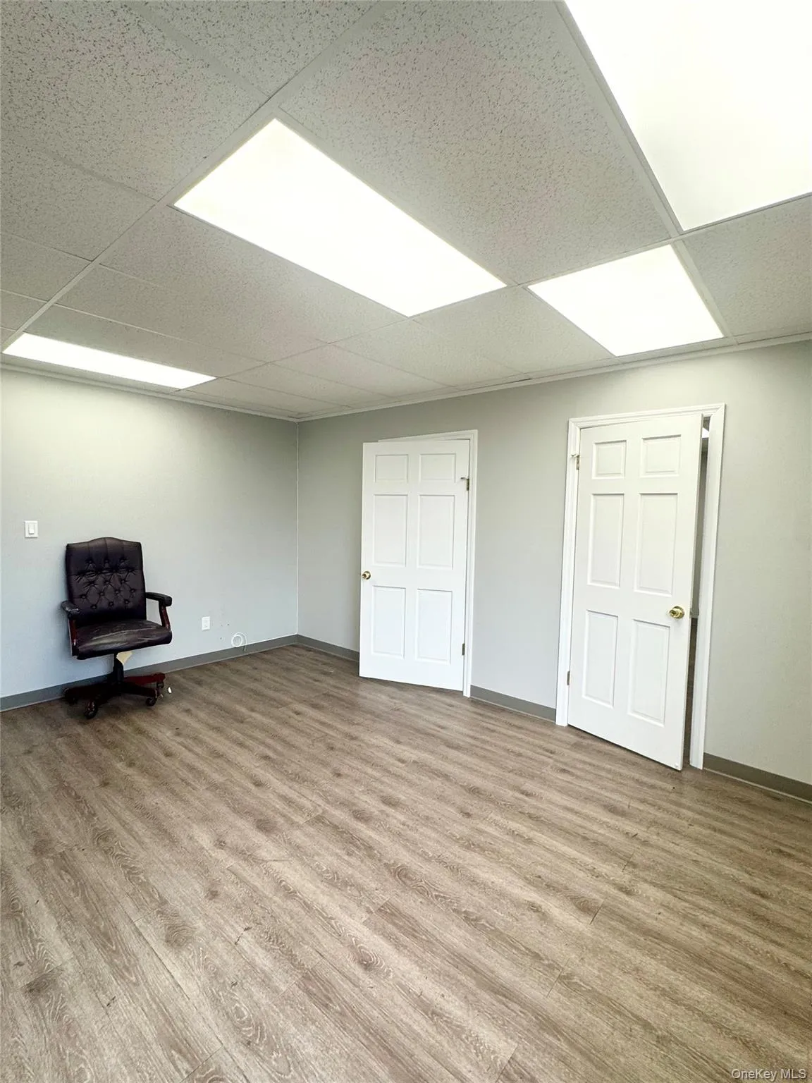 Basement with light wood finished floors and a paneled ceiling Basement with light wood finished floors and a paneled ceiling