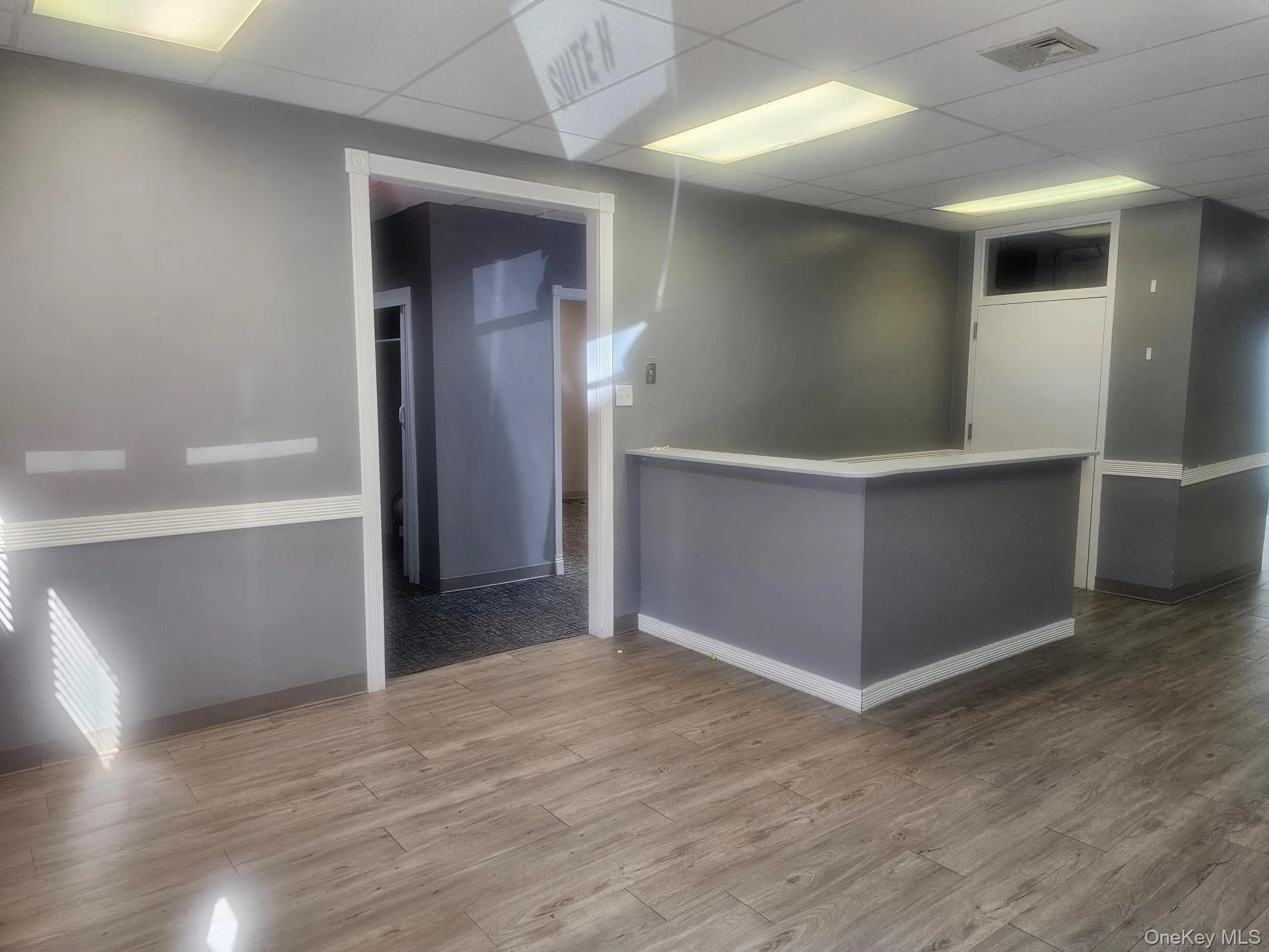 Main Room with Reception Desk with Entry into Hallway with 2 Half Baths Main Room with Reception Desk with Entry into Hallway with 2 Half Baths