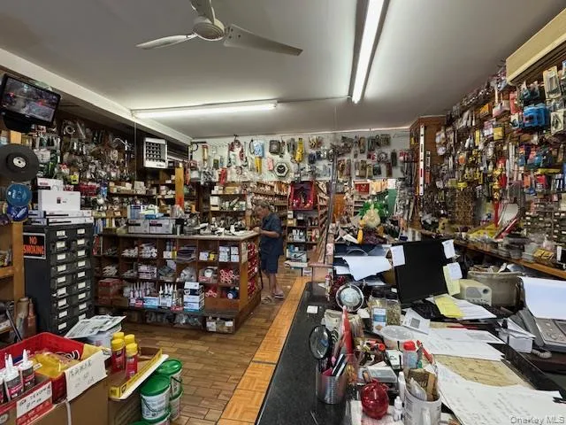 Miscellaneous room featuring ceiling fan and a workshop area Miscellaneous room featuring ceiling fan and a workshop area