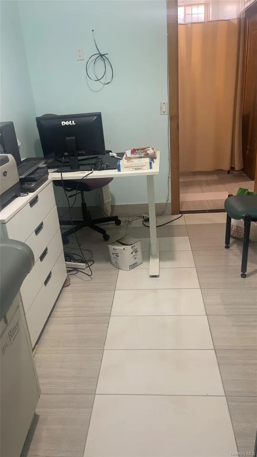 Office with light tile patterned floors Office with light tile patterned floors