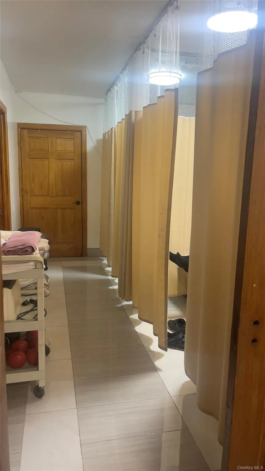 Hall featuring light tile patterned floors Hall featuring light tile patterned floors