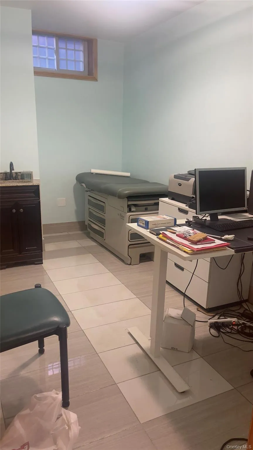 Office space featuring light tile patterned floors and a sink Office space featuring light tile patterned floors and a sink