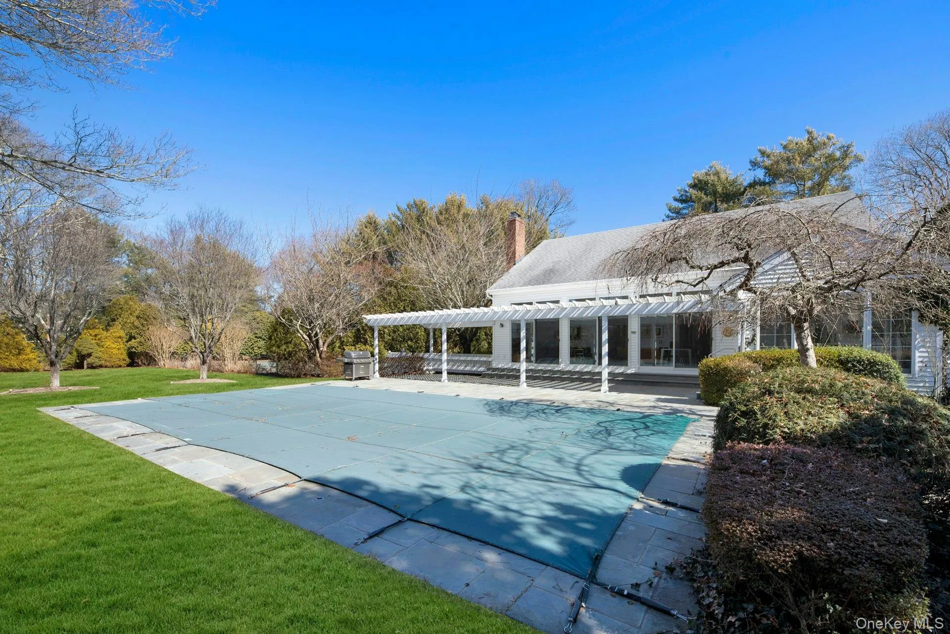 Side overview of entertaining and recreation area featuring patio, pool, tennis, park like backyard Side overview of entertaining and recreation area featuring patio, pool, tennis, park like backyard