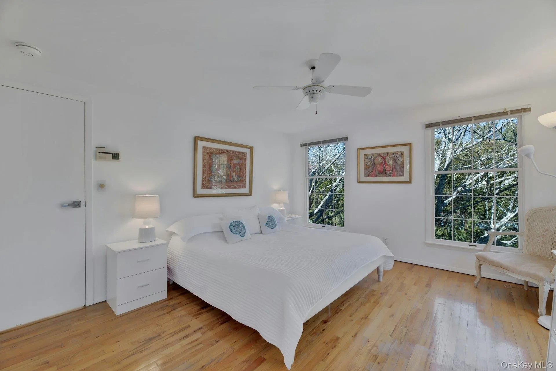Bedroom featuring light wood-style floors and a ceiling fan Bedroom featuring light wood-style floors and a ceiling fan