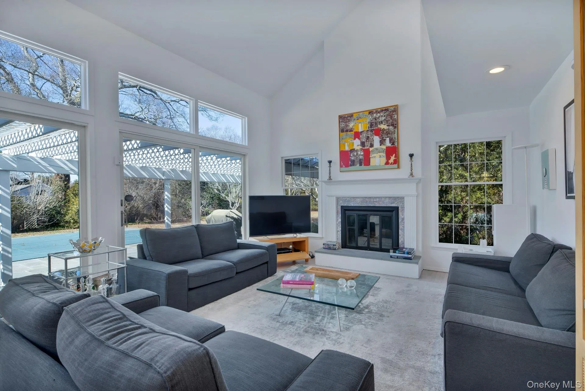 Living area with a fireplace, cathedral ceilings and recessed lighting Living area with a fireplace, cathedral ceilings and recessed lighting