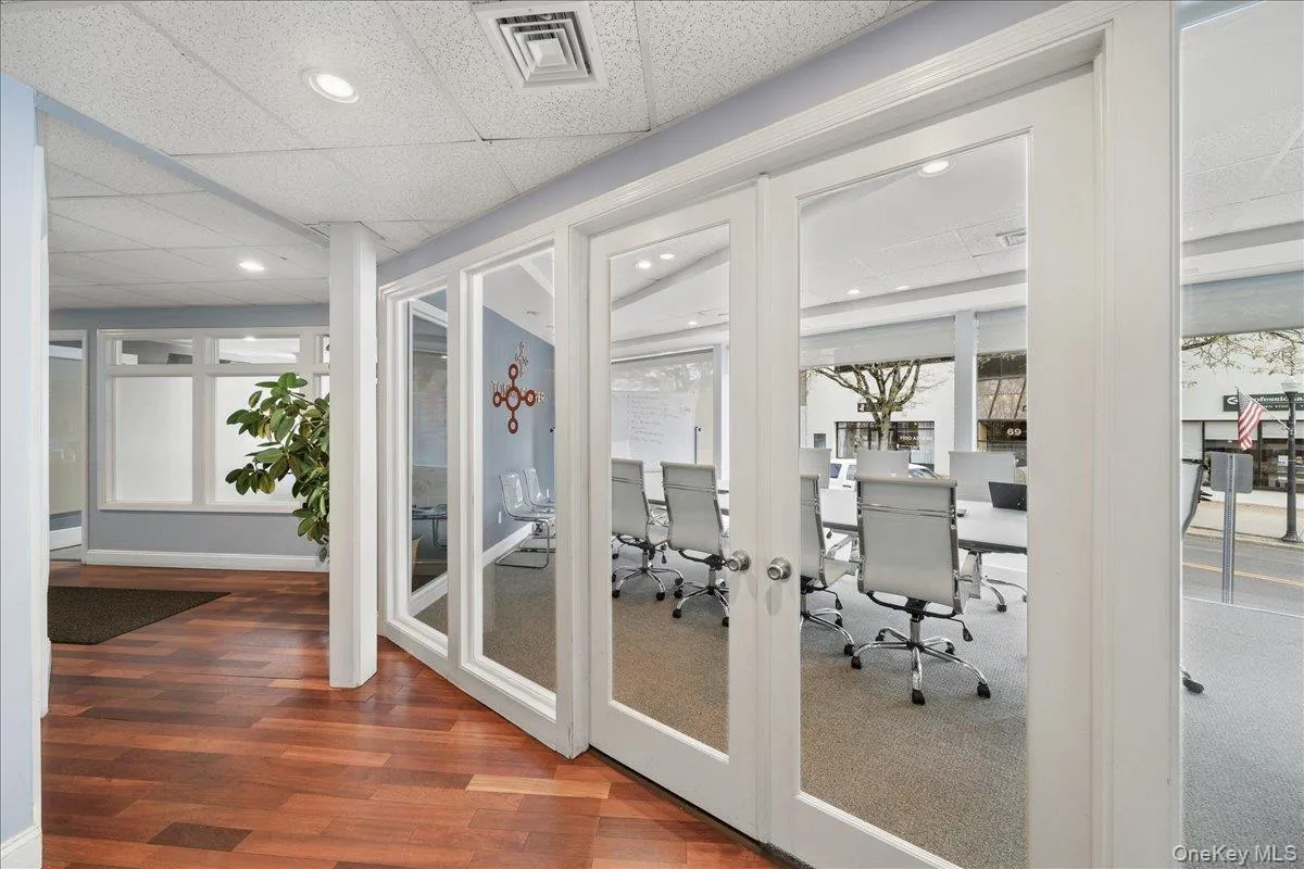 Exercise room with a drop ceiling, recessed lighting, and dark wood-style floors Exercise room with a drop ceiling, recessed lighting, and dark wood-style floors