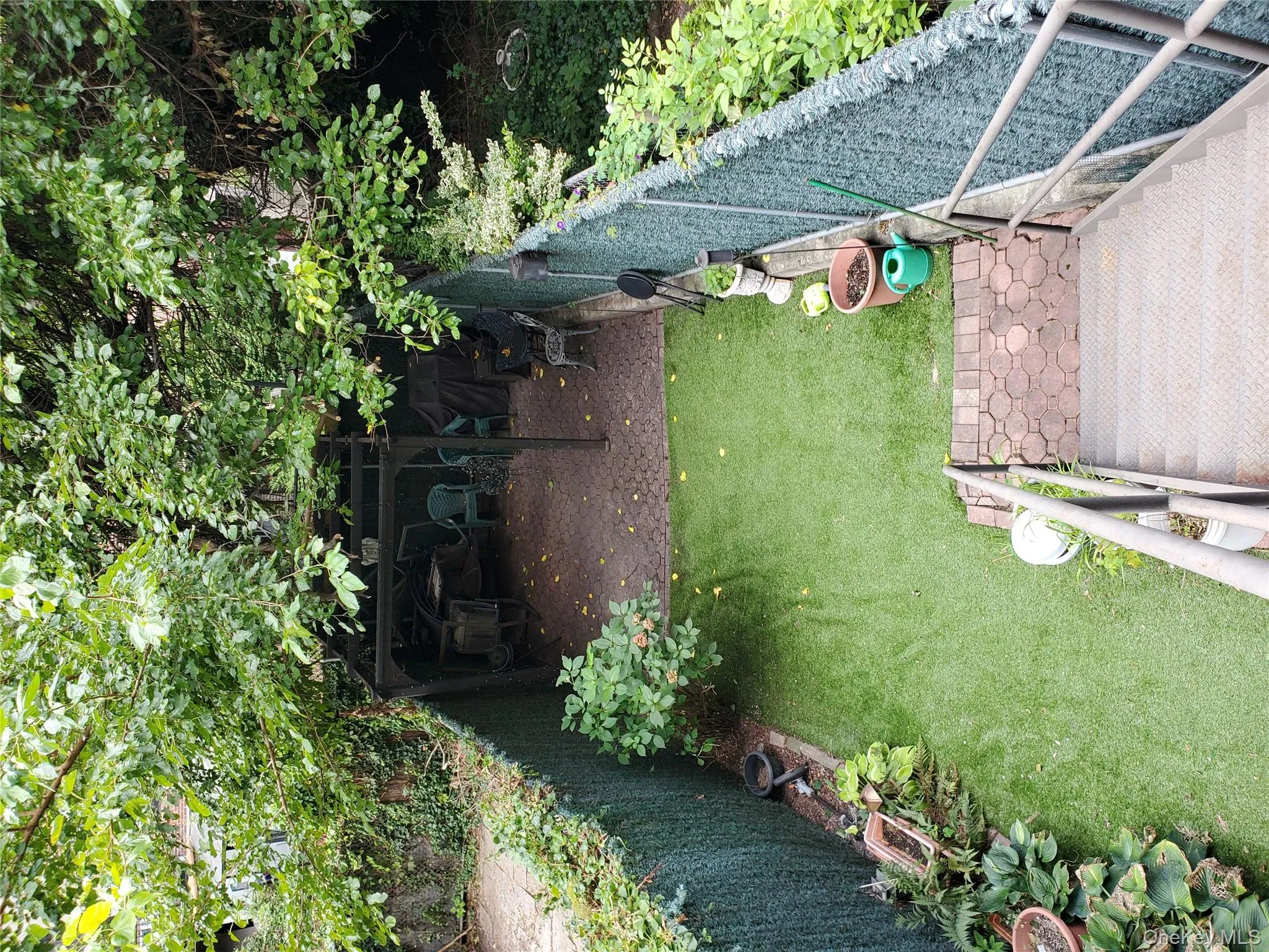 Fenced backyard with a patio area Fenced backyard with a patio area